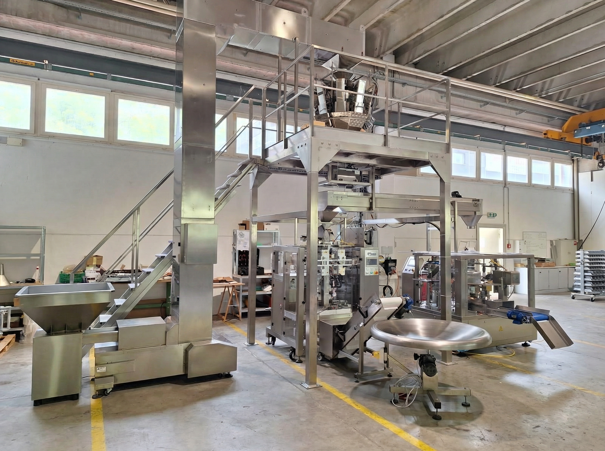 Automated bucket conveyor and multihead weigher delivering product to DoyPack and VFFS packaging machines in Germany