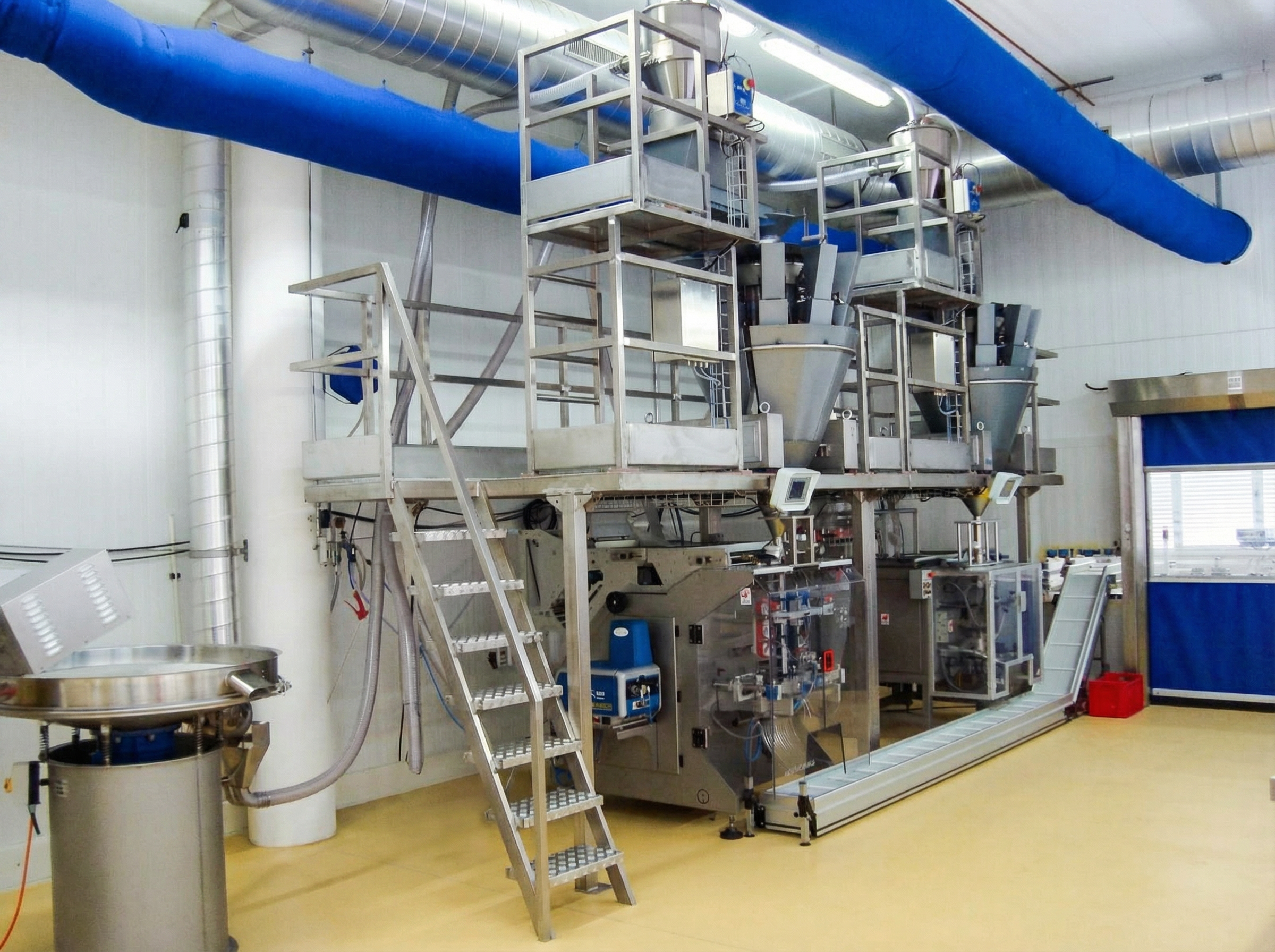 Space-optimized multi-dosing system with auger filler and multihead weigher installed in an Italian packaging facility