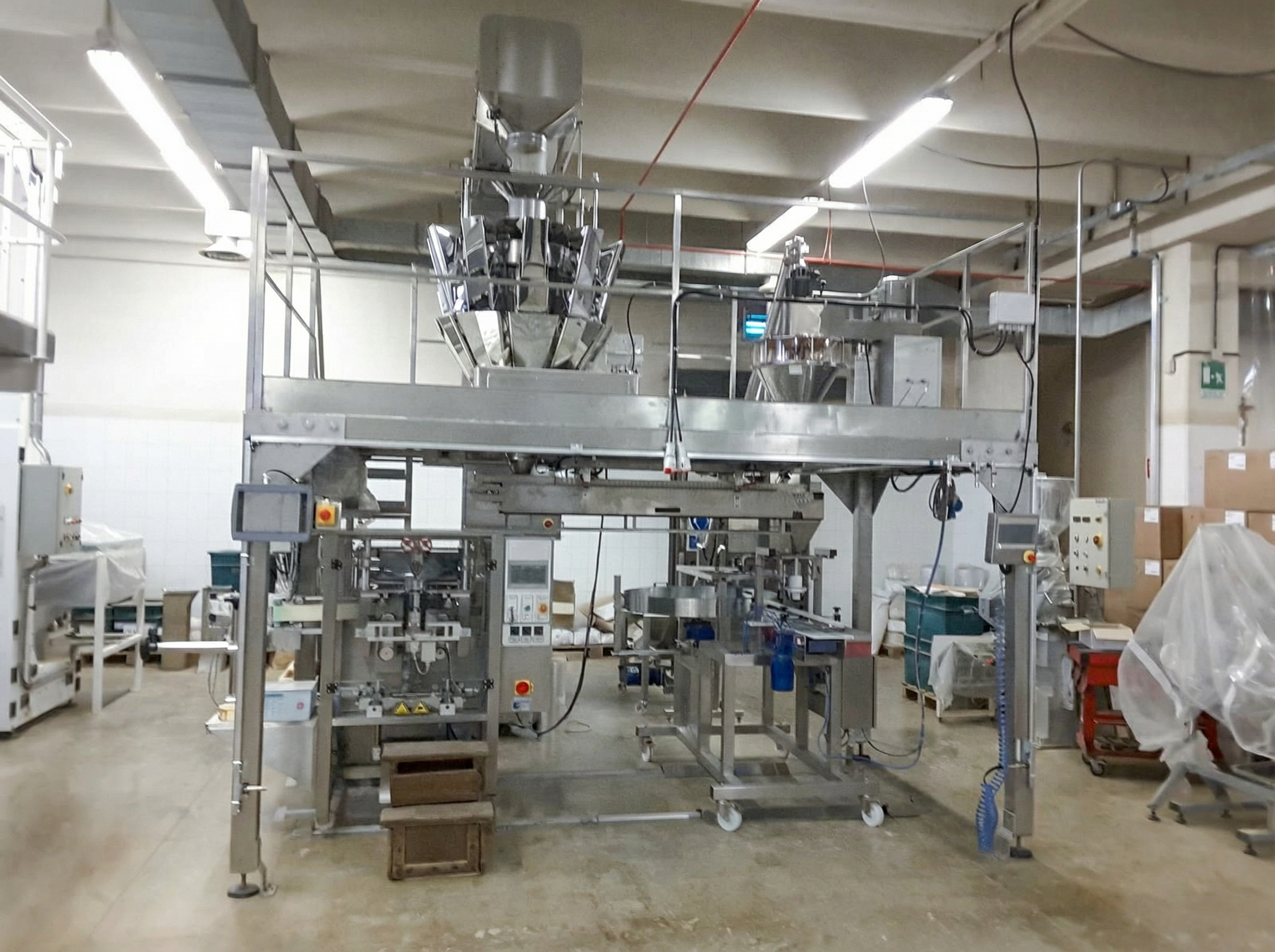 Plant expansion testing unit with custom carpentry maximizing space for multihead weigher and auger filler in Switzerland
